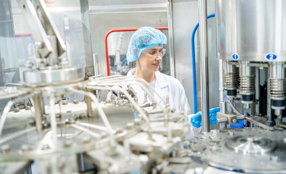 female-worker-inspecting-water-bottle